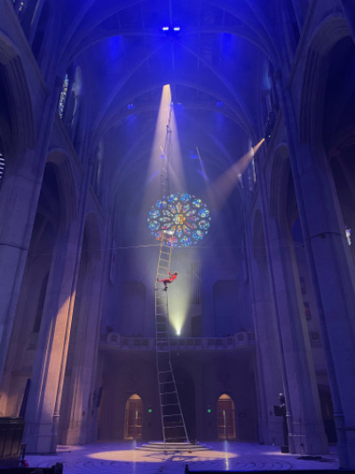 Aerial dancer on an 80 foot ladder suspended at Grace Cathedral in San Francisco.