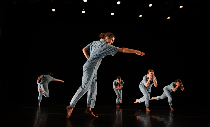 Six dancers in light blue jumpsuits caught in action. Six dancers in light blue jumpsuits caught in action.